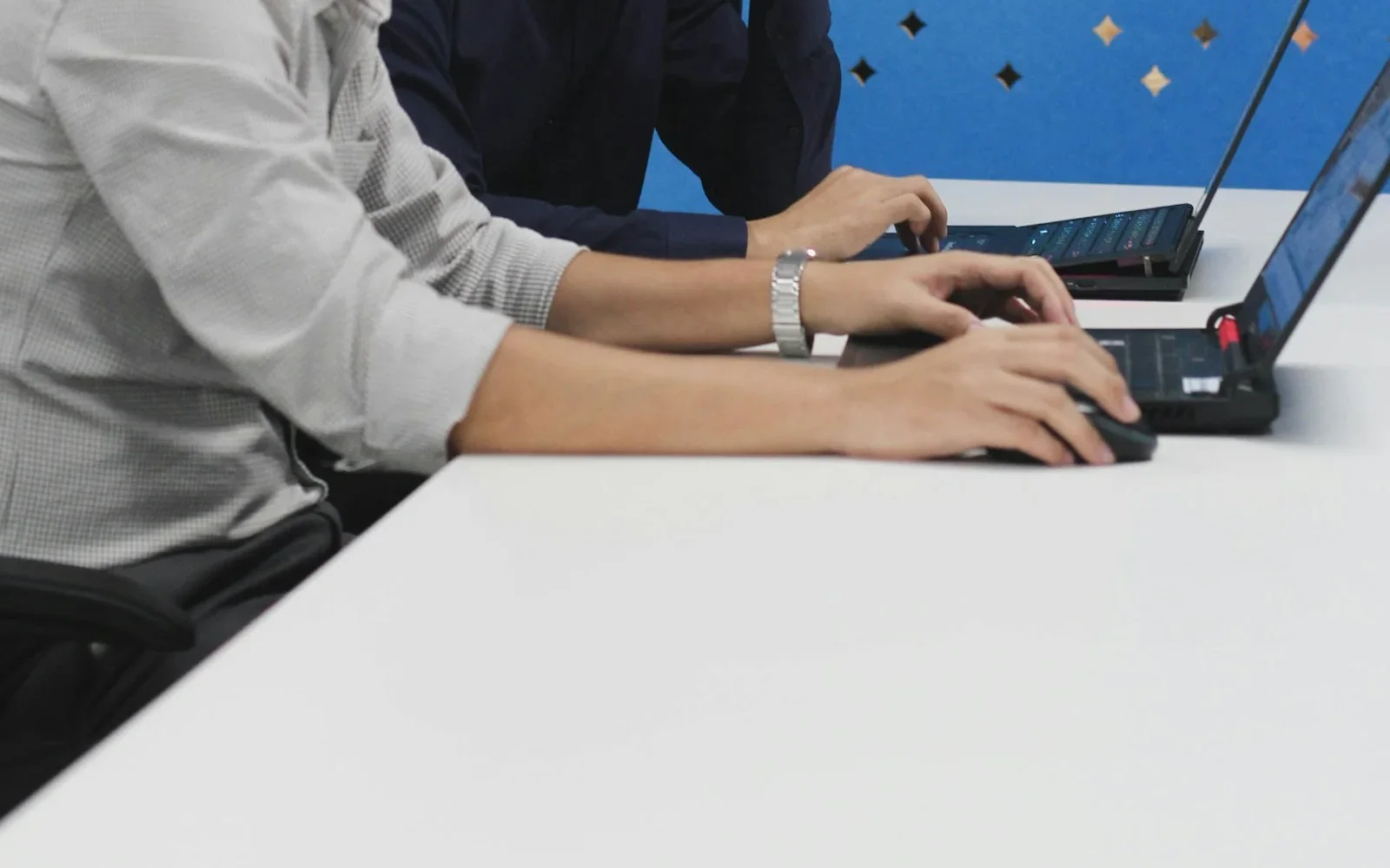 Asian colleagues using Microsoft 365 Office apps together on a laptop