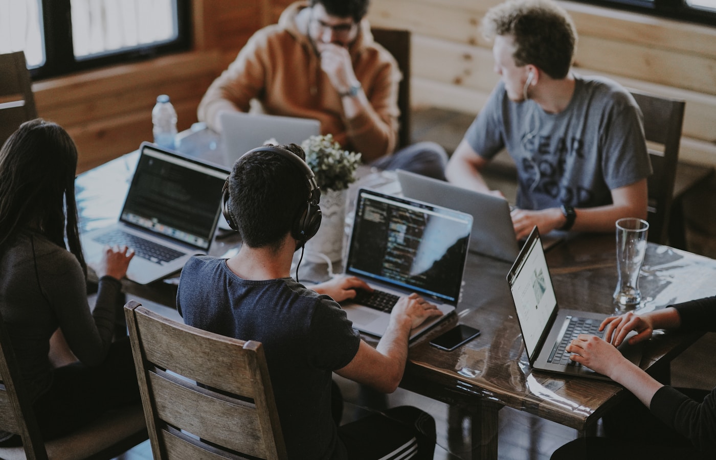 Small business team using Microsoft 365 Business Basic on laptops in a modern office.